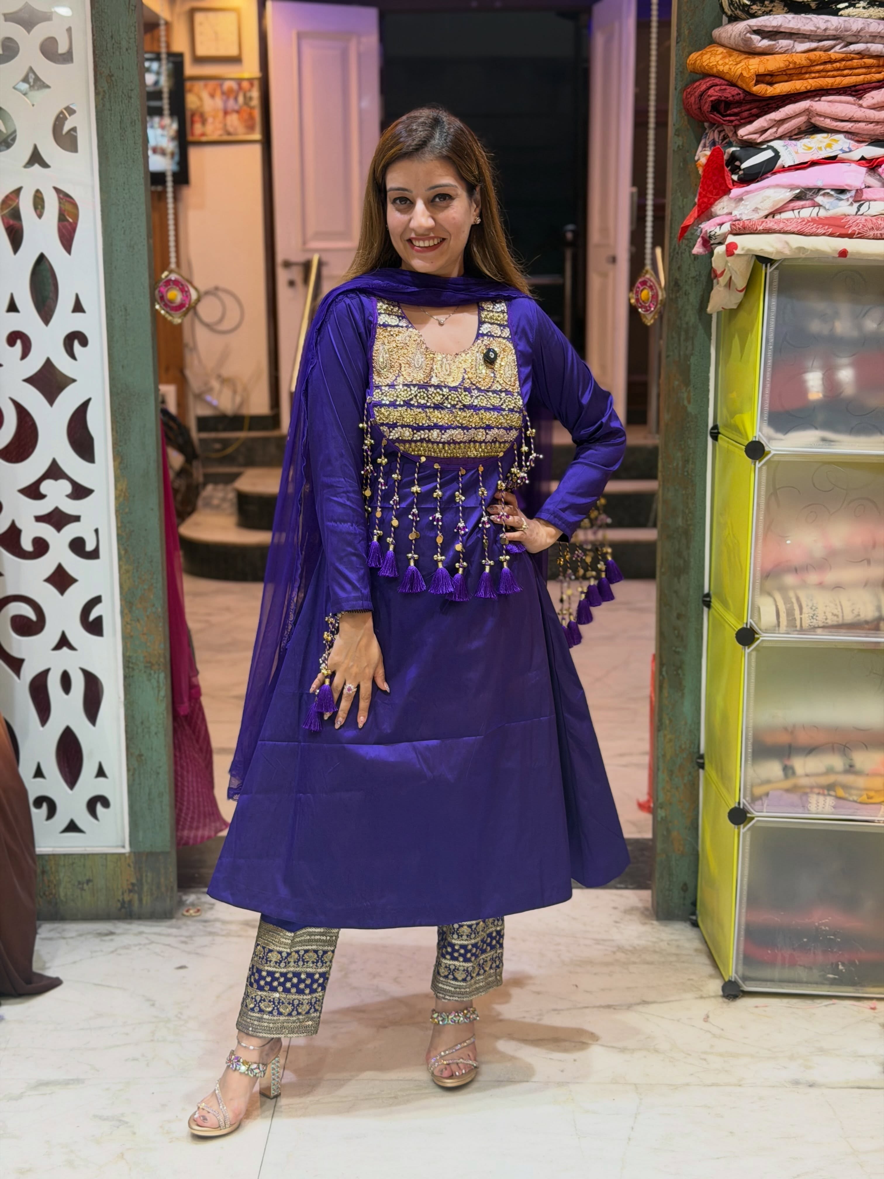 Qayanat royal-purple suit with golden embroidery and tassels